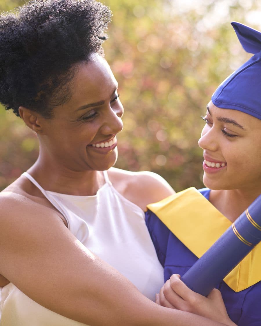 A graduate celebrating with family