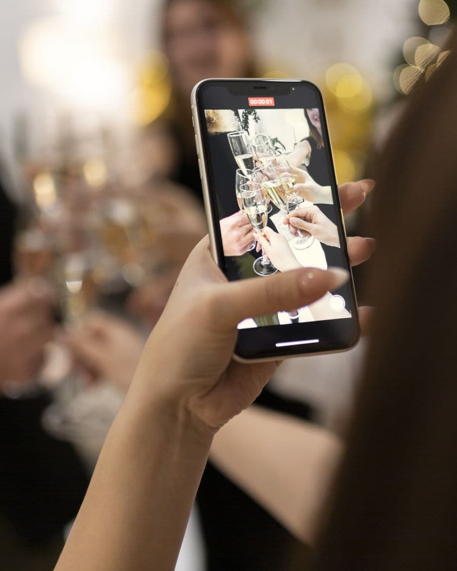 A toast at a holiday party filmed on a phone