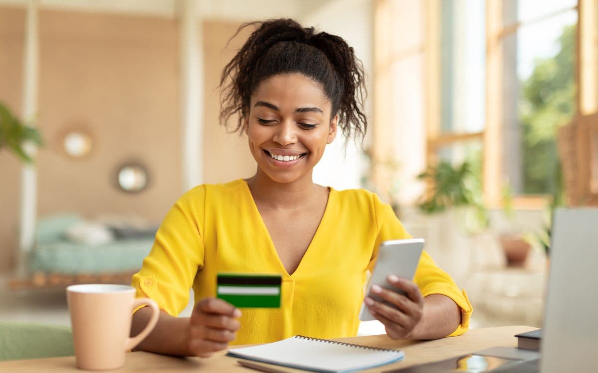A woman buying a gift on her phone at home